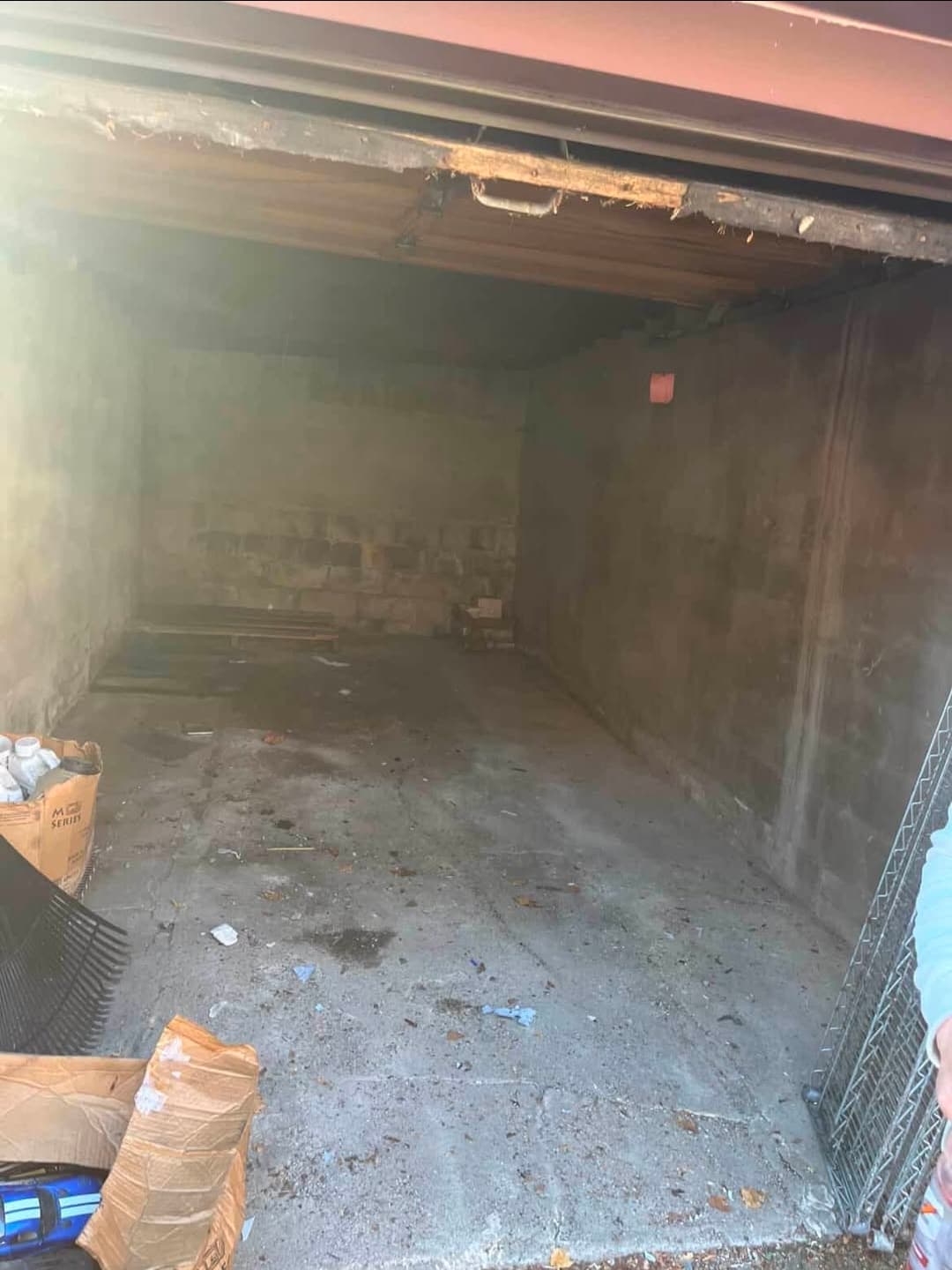 Empty garage with bare concrete floor after complete cleanout