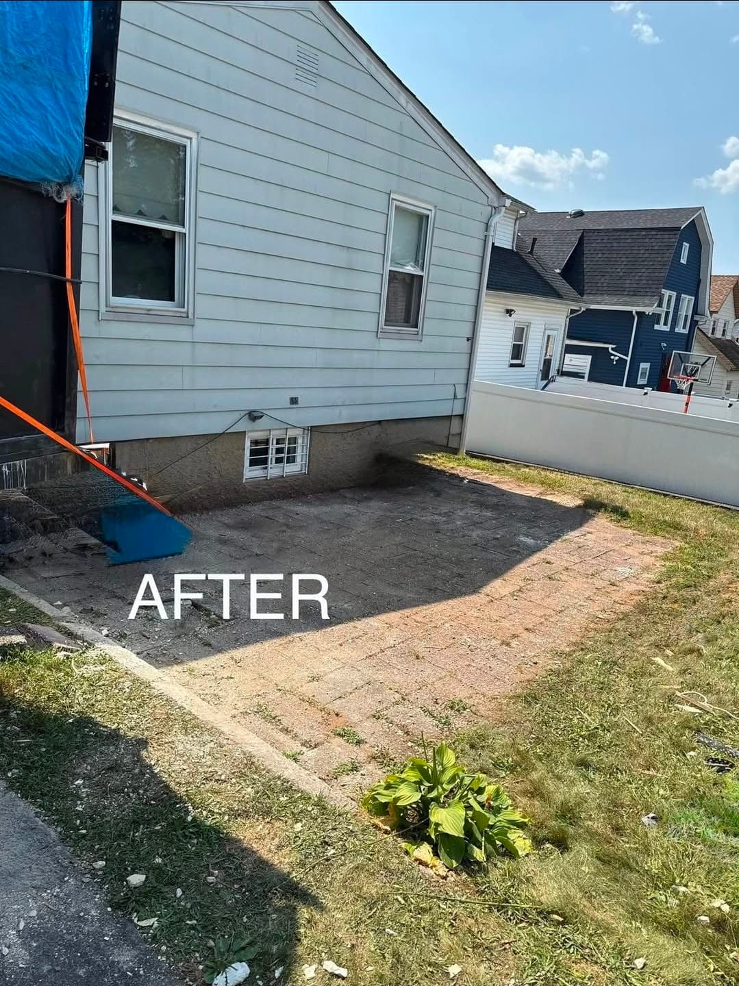 Clean side yard with cleared rectangular area after debris removal